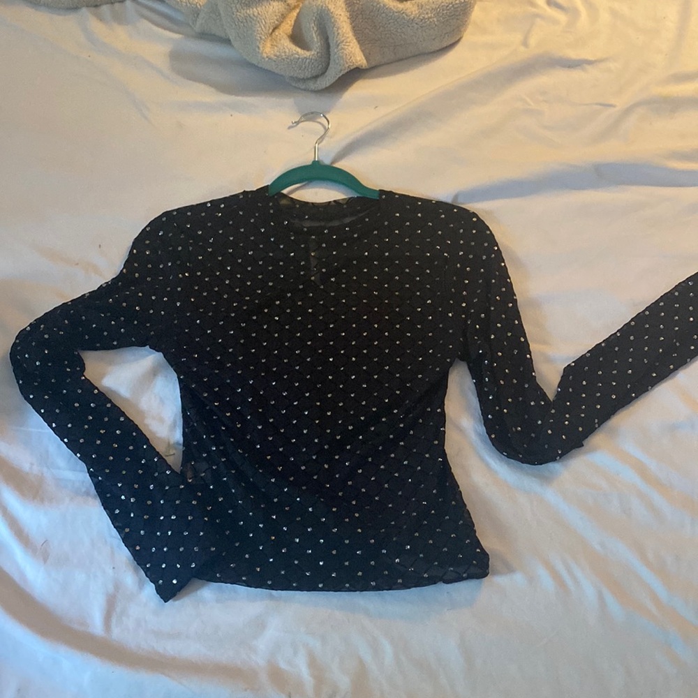 I am selling  this beautiful sheer . See thru black shirt